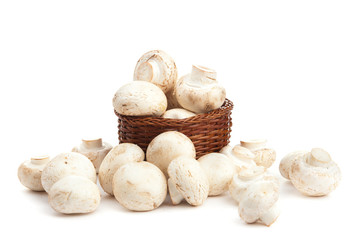 champignones in wooden basket isolated on white