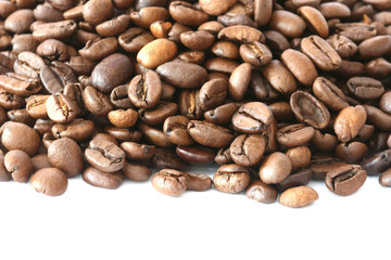 Whole coffee beans scattered on white background