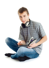 The teenager listens to music