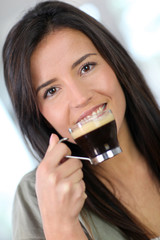 Portrait of beautiful woman drinking expresso