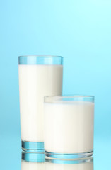 Two glass of milk on blue