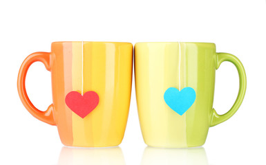 Two cups and tea bags with red and blue heart-shaped label