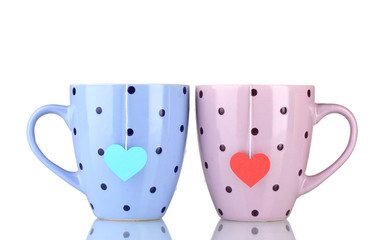Two cups and tea bags with red and blue heart-shaped label
