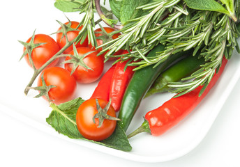 fresh vegetables in plate isolated on white background
