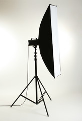 Studio flash with soft-box on white background