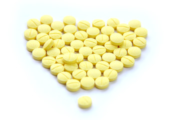 Yellow pills on white background