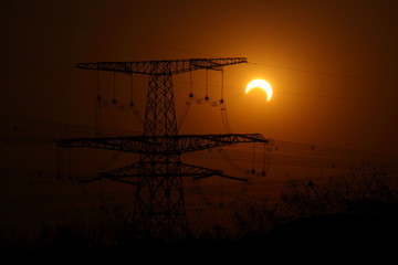 High-voltage lines under partial solar eclipse