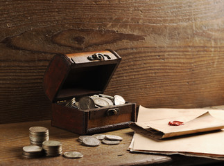 Treasure chest, old coins and mail paper
