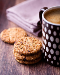 Closeup of  cinnamon cookies with nuts and mug of coffee
