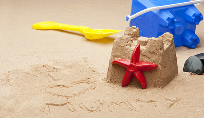 Fototapeta na wymiar childs sandcastle on beach.
