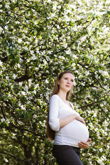 Beautiful pregnant woman relaxing in the park