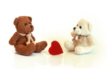 Deux ours en peluche et un coeur rouge