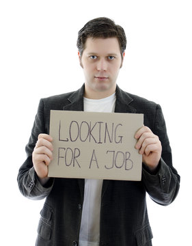 Unemployed with a sign LOOKING FOR A JOB.