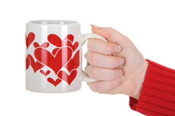 Female Hand Holding a Cup With Red Hearts