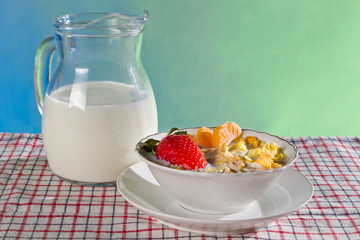 Fresh fruits with corn flakes and milk jug