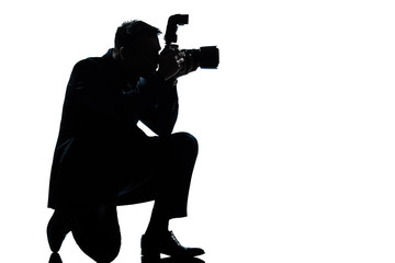 Fototapeta na wymiar silhouette man kneeling photographer