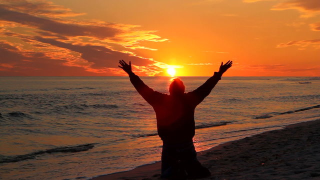 Man Kneeling At Sunset