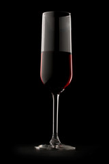 Glass of red wine in black