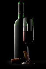 Bottle and glass of wine in black