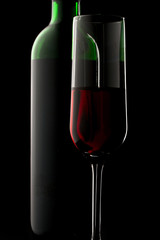 Bottle and glass of wine in black