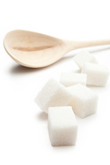 Cubes of sugar with wooden spoon