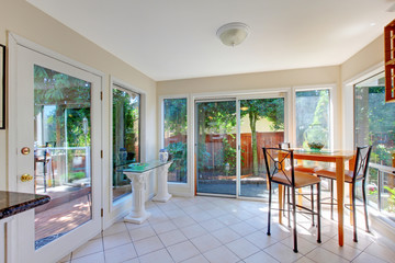 Dining room with lots of windows and small dining table