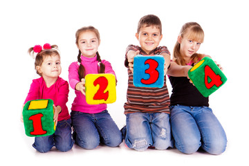 Fototapeta na wymiar Szczęśliwe dzieci trzymając bloki z numerami