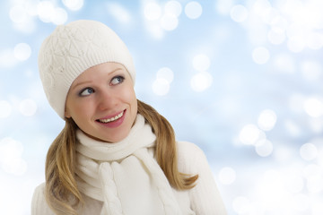 beautiful happy young woman in a winter hat and scarf