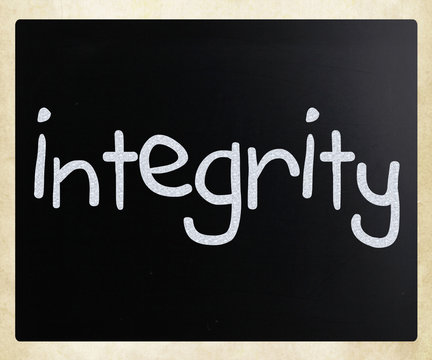 "Integrity" handwritten with white chalk on a blackboard
