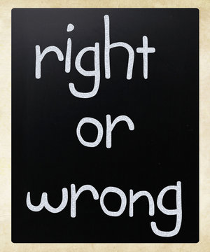 "Right or wrong" handwritten with white chalk on a blackboard