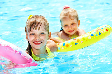 Child sitting on inflatable ring..