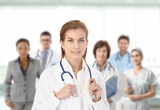 Young female doctor in front of medical team
