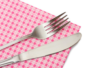 Fork and knife in a plaid cloth  isolated on white