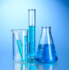 Laboratory glassware with blue liquid with reflection