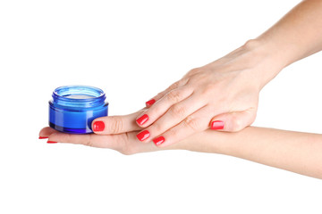 Female hands with manicure holding cream isolated on white