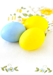Fototapeta na wymiar Three multi colored eggs on a napkin.