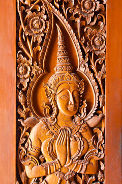 Thai style wood carving on door temple