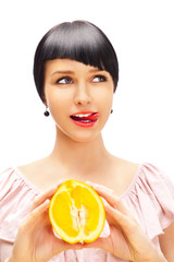 Have a lick. Pretty woman with delicious orange in her arms.