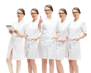 Portrait of young pretty doctor thumbs up with her clones in dif