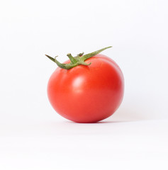 closeup of one red tomato on white background