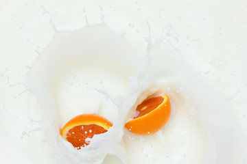 Orange and splashing milk
