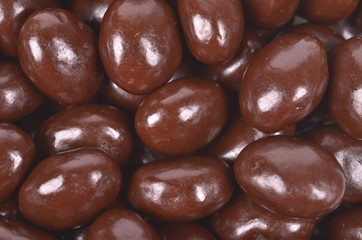 Dark brown dragee, chocolate covered nuts,