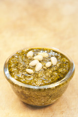 Pesto on wooden background