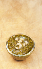 Pesto on the wooden background