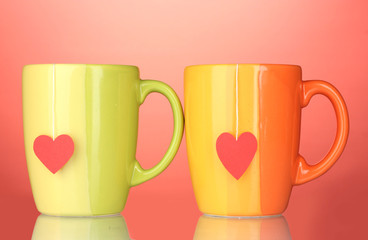 Two cups and tea bags with red heart-shaped label