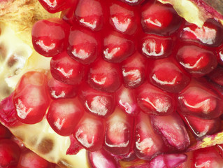 Extreme close up background of a red juicy ripe pomegranate frui