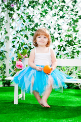 little girl sitting on a bench