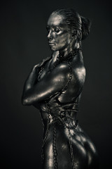 Fototapeta na wymiar Nude woman like statue in liquid metal