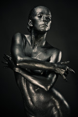 Fototapeta na wymiar Nude woman like statue in liquid metal