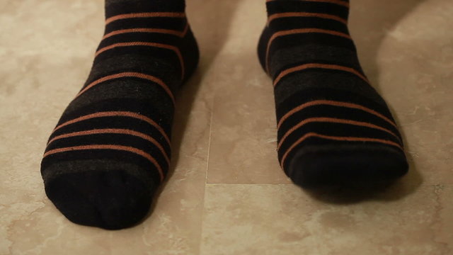 Man legs in brown strip socks